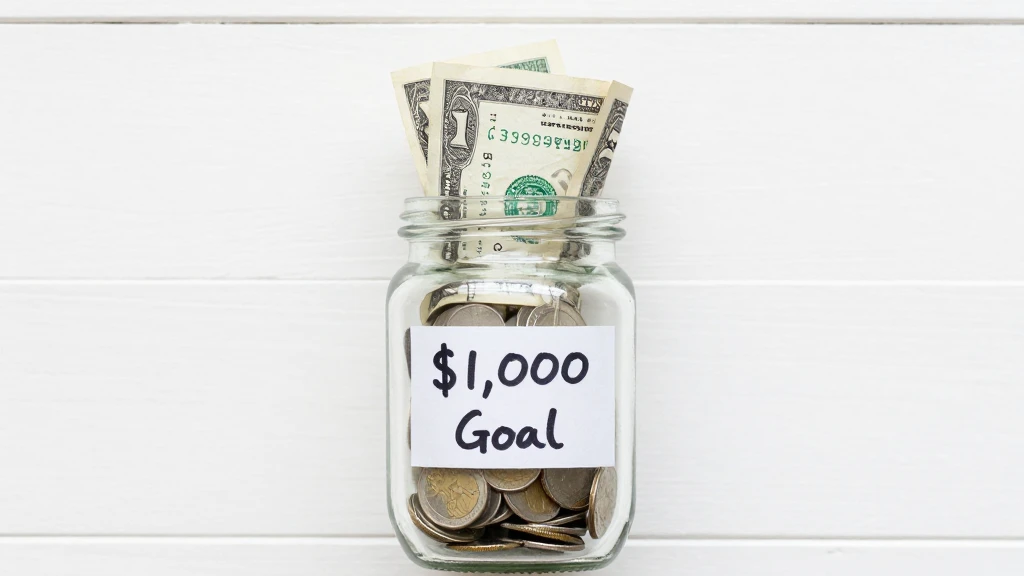 save your first $1000 fast with a coin jar savings goal plan