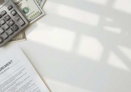 Personal loan calculator USA showing monthly payment calculation on a desk