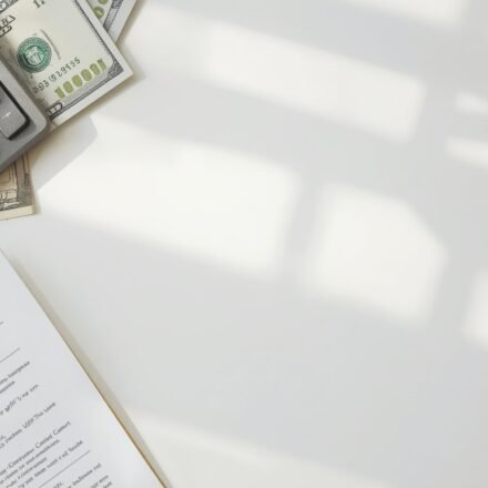 Personal loan calculator USA showing monthly payment calculation on a desk